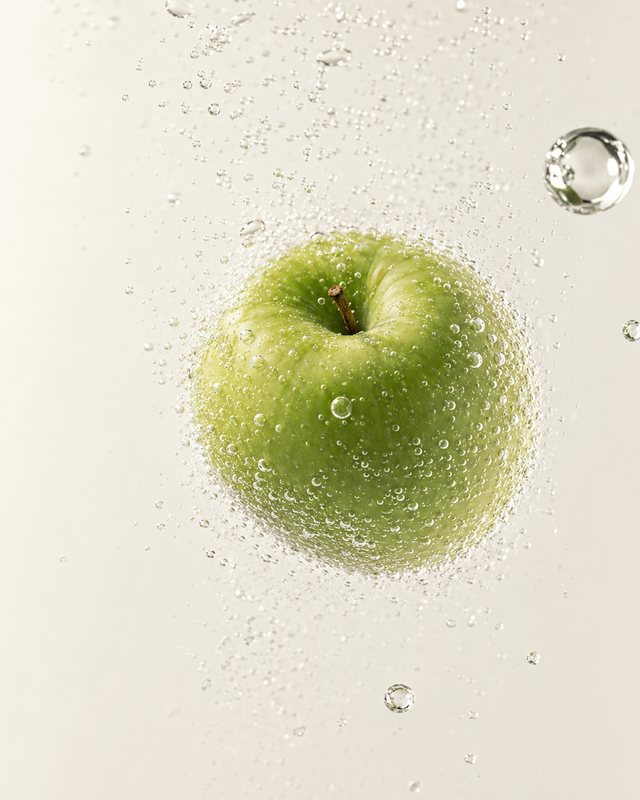 Manzana verde entre burbujas de agua